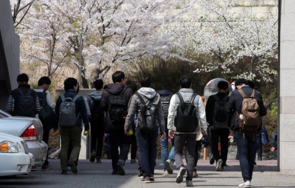 ▲11일 오후 서울 잠실고등학교에서 현대차그룹 인적성검사(HMAT)를 치른 응시생들이 귀가하고 있다. 이들 뒤로는 벚꽃이 만개해 있다.(출처=연합뉴스)