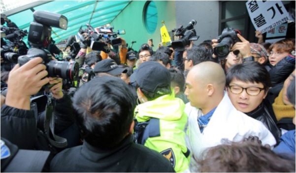 ▲9일 오후 민주노총 한상균 위원장 은신처인 서울 종로구 조계사 관음전 출입구를 지키던 조계사 직원 등이 해산 시도를 하려는 경찰들과 충돌하고 있다. 연합뉴스 
