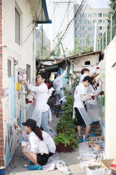 ▲LG전자 대학생 CSR 아카데미 ‘러브지니'가 5일 서울 영등포구의 한 낡은 골목을 찾아 벽화 그리기 봉사를 하고 있다. 사진제공 LG전자