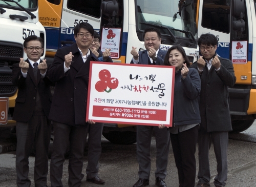 ▲유진기업 직원들이 레미콘 믹서트럭에 캠페인 홍보스티커를 부착하고 기념사진을 촬영하고 있다. (사진제공=유진그룹)