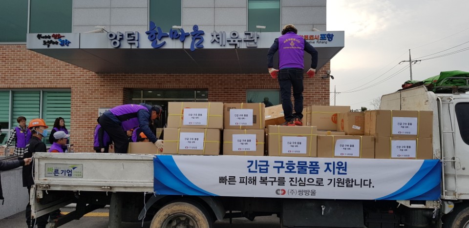 ▲쌍방울 직원들이 17일 포항 지역 지진 피해 이재민들이 머물고 있는 양덕 한마음 체육관에 구호물품을 전달하고 있다.(사진 = 쌍방울)
