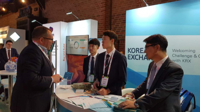 ▲신홍희 한국거래소 파생상품시장본부 상무(사진 오른쪽)가 5일 런던 엑스포 행사장에서 한국거래소 부스를 찾은 해외 기관투자자에게 국내 파생상품시장을 설명하고 있다.(사진제공=한국거래소)