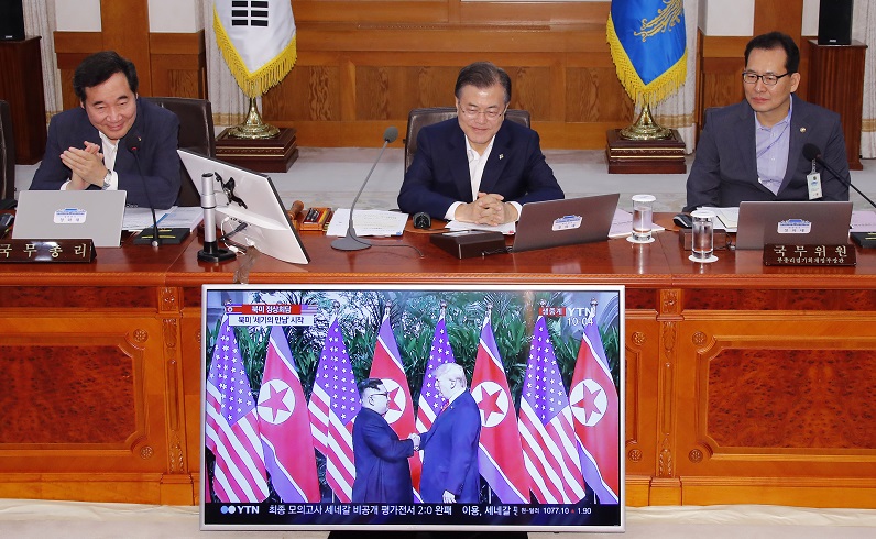 ▲문재인 대통령이 12일 오전 청와대에서 열린 국무회의에서 김정은 북한 국무위원장과 도널드 트럼프 미국 대통령이 역사적인 첫 만남을 갖는 모습을 방송을 통해 지켜보며 흐뭇한 표정을 짓고 있다. (연합뉴스)