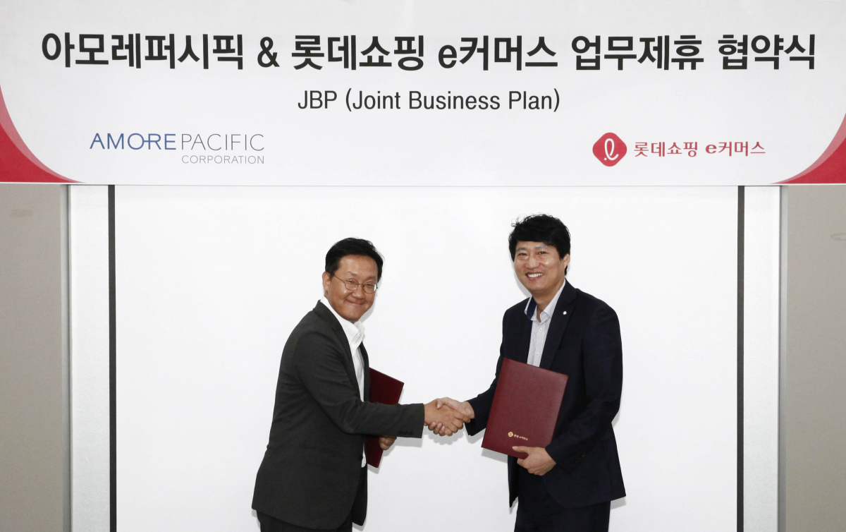 ▲롯데쇼핑 e커머스 영업본부 전문사업부문장 김장규 상무(우)가 아모레퍼시픽 디지털Division 사업부장 이민규 상무(좌)와 업무제휴 협약(JBP)을 체결한 후 악수를 나누고 있다. (사진제공=롯데쇼핑)