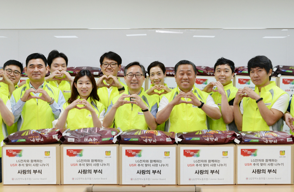 ▲LG전자 노동조합이 한가위를 앞두고 소외되기 쉬운 우리 주변 이웃에게 따뜻한 사랑을 전했다. 서울 가산동 LG전자 노동조합 사무실에서 배상호 노조위원장(오른쪽에서 세번째)과 유성훈 금천구청장(오른쪽에서 다섯번째)을  비롯한 LG전자 직원들이 직접 포장한 사랑의 부식 박스 앞에서 포즈를 취하고 있다. (사진제공 LG전자)