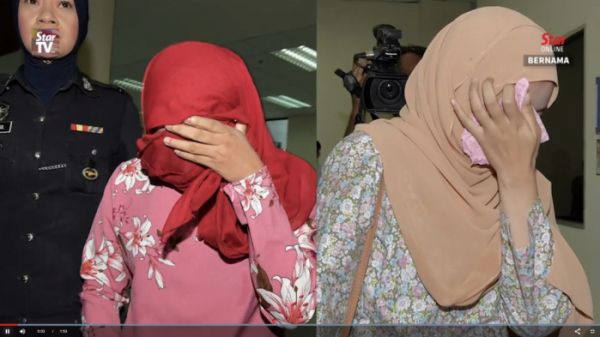 ▲동성애 성행위를 시도한 혐의로 유죄 판결을 받은 말레이시아 무슬림 여성 2명의 모습.(뉴시스)