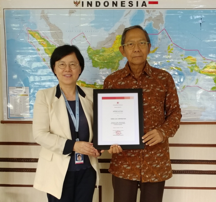 ▲정은경 한국가스공사 인도네시아 법인 액화사업(DSLNG) 이사가 16일(현지시간) 인도네시아 적십자사 기난자르(Ginandjar) 부총재에게 지진 피해 구호 성금을 전달한 뒤 기념촬영을 하고 있다.(한국가스공사)