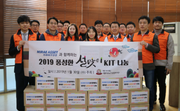 ▲미래에셋 임직원들이 31일 서울 동작구에 있는 재가노인지원센터를 찾아 설 선물을 전하고 기념촬영을 하고 있다.(사진제공=미래에셋생명)