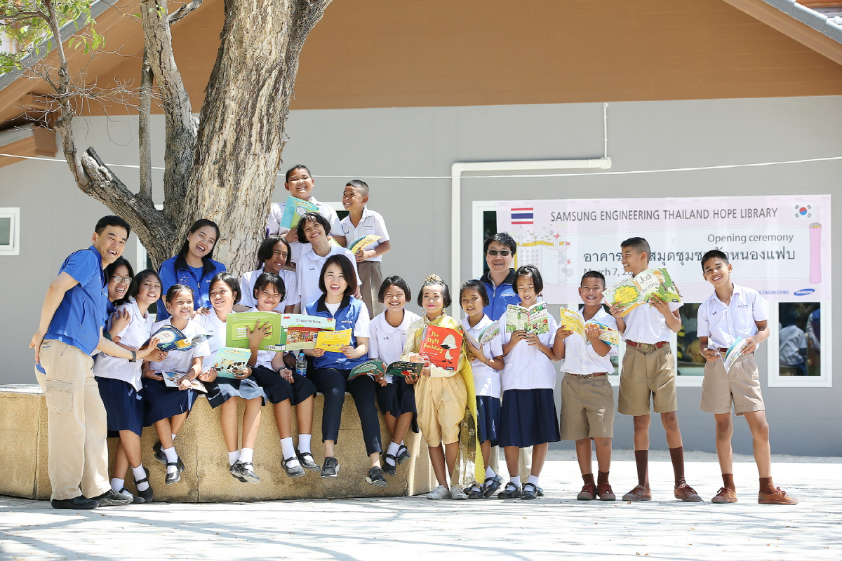 ▲삼성엔지니어링 임직원과 태국 농팝마을 아이들이 태국 '희망도서관' 앞에서 기념촬영 하는 모습.(사진제공=삼성엔지니어링)