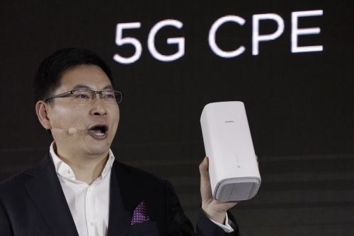 ▲리차드 유 중국 화웨이 CEO가 1월 24일 베이징에서 열린 5G 발표회에서 5G 모뎀 바롱 5000에 연동하는 무선 라우터를 선보이고 있다. 베이징/AP뉴시스
