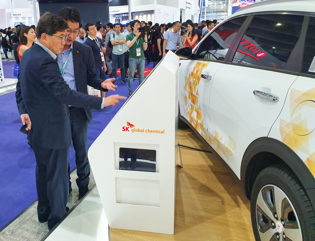 ▲나경수(왼쪽) SK종합화학 사장이 22일 차이나플라스 현장을 찾아 자사 오토모티브 존 부스를 둘러보고 있다.(사진 제공=SK이노베이션)