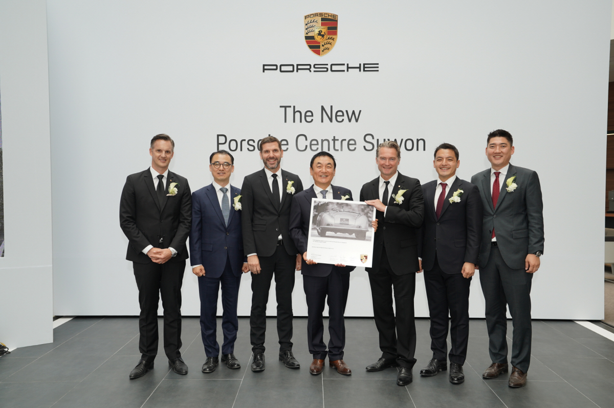▲18일 포르쉐 센터 수원 개관식에서 권오수 도이치오토모빌그룹 회장과 마티아스 베커 포르쉐 AG 해외 및 신흥시장 담당 부사장이 함께 한 현판 전달식이 진행되고 있다. (사진제공=도이치오토모빌그룹)