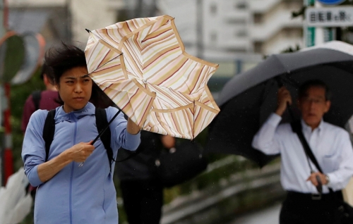 ▲일본에 15호 태풍 파사이가 상륙한 가운데 9일(현지시간) 도쿄에서 사람들이 비바람을 뚫고 출근길에 나서고 있다. 도쿄/로이터연합뉴스 

