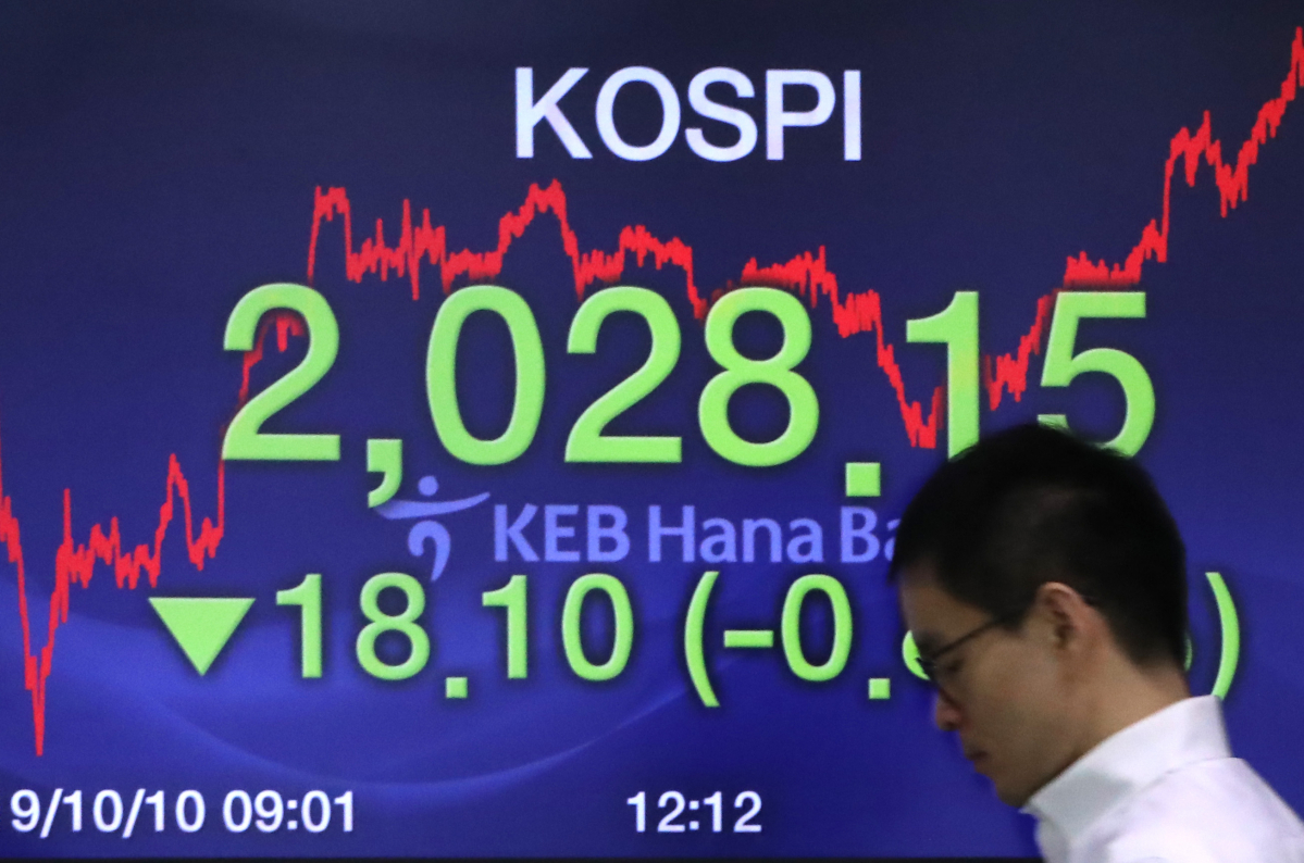 ▲코스피가 18.10포인트 하락한 2028.15로 장을 마감한 10일 서울 중구 KEB 하나은행 딜링룸에서 한 딜러가 전광판 앞을 지나고 있다. (연합뉴스)