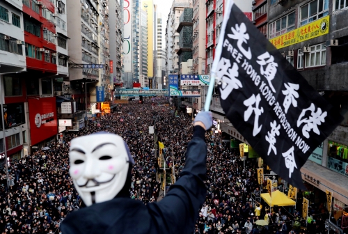 ▲홍콩에서 8일(현지시간) 세계 인권의 날을 맞아 약 80만 명이 참가한 대규모 시위가 벌어지고 있는 가운데 한 시위자가 가이 포크스 가면을 쓰고 깃발을 흔들고 있다. 홍콩/로이터연합뉴스 
