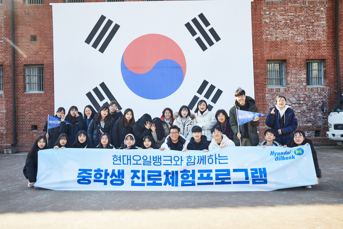 ▲윤제균 감독(맨앞줄 왼쪽에서 7번 째)과 부춘 중학교 학생들이 6일 서대문 형무소 앞에서 기념 사진을 찍고 있다. (사진제공=현대오일뱅크)