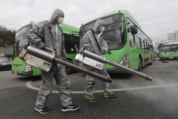 ▲서울의 한 버스차고지에서 26일 근로자들이 마스크를 쓰고 방역 작업을 하고 있다. 서울/AP연합뉴스
