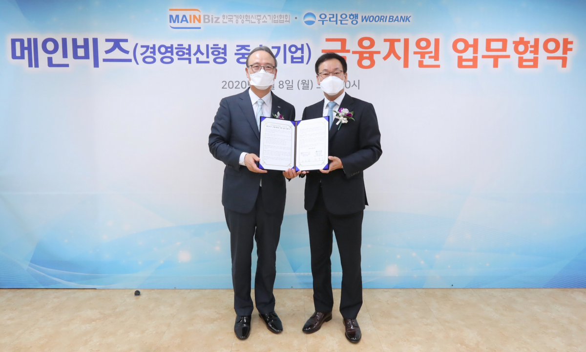 ▲박완식(오른쪽) 우리은행 중소기업그룹장이 석용찬 메인비즈협회장과 기념촬영을 하고 있다.