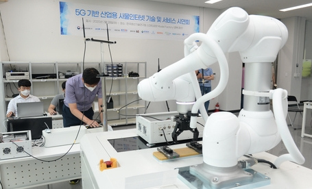 ▲5G 기술 이용해 이동형 로봇 제어하는 ETRI 연구팀 (ETRI 제공)