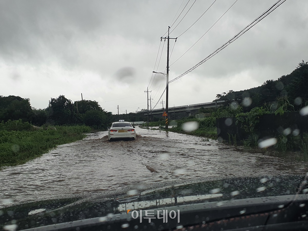 ▲4일 오전 경기도 포천시에 시간당 54mm의 집중호우가 쏟아진 가운데, 포천시 영중면 한 도로가 침수돼 차량 통행에 어려움을 겪고 있다. (독자제공)