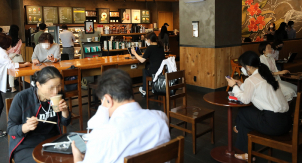 ▲사회적 거리두기가 2주간 2단계로 완화된 14일 오후 서울 서초구의 한 프랜차이즈 카페에서 시민들이 커피를 주문하고 있다. 이번 조치로 밤 9시 이후 매장영업을 할 수 없었던 음식점과 영업시간 내내 매장 좌석을 이용할 수 없었던 프랜차이즈 카페를 정상적으로 이용할 수 있다. (뉴시스)