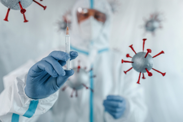 ▲Scientist in protective suit preparing to inject coronavirus antidote vaccine