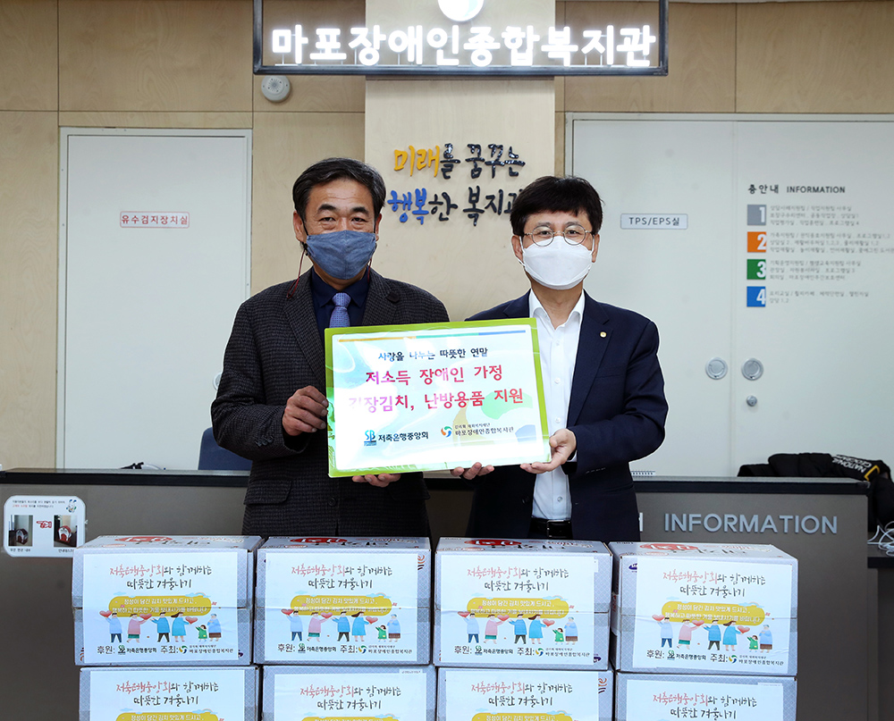 ▲저축은행중앙회 조정연(우측) 상무와 마포장애인복지관 김명규 사무국장이 '저소득 장애인 가정을 위한 김장김치와 난방용품 지원' 행사를 마친 후 기념촬영을 하고 있다. (사진제공=저축은행중앙회)