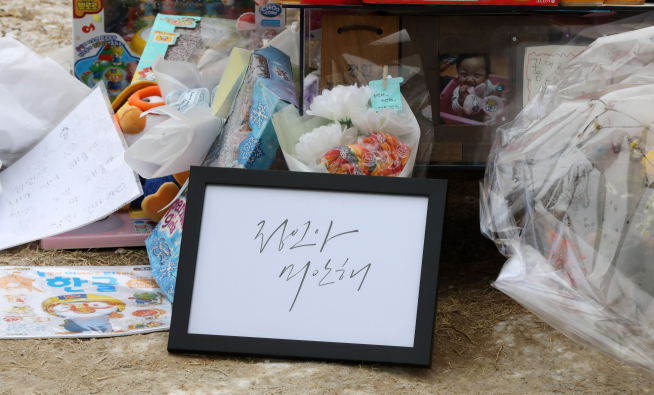 ▲고(故) 정인 양의 묘지를 찾은 추모객들이 두고 간 선물과 메시지 등이 놓여 있다.  (뉴시스)