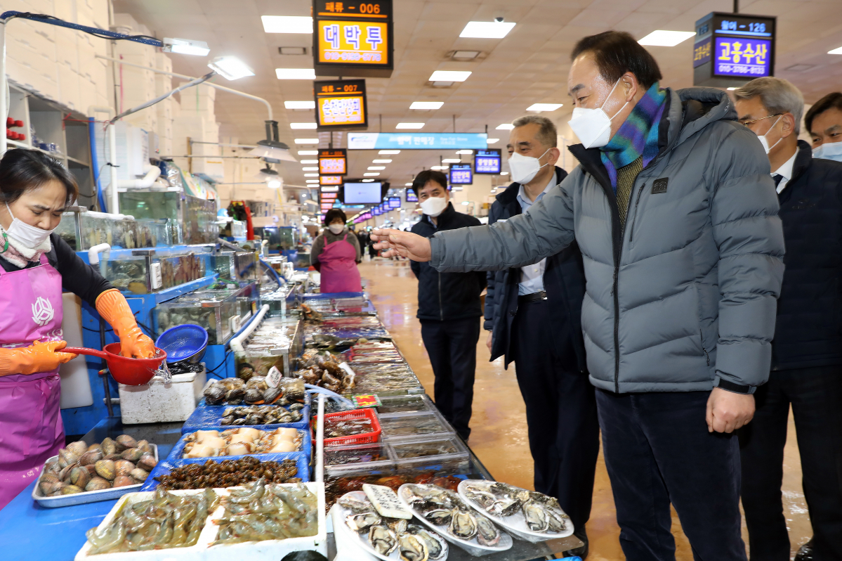 ▲임준택 수협중앙회장이 12일 노량진수산시장에서 수산물 판매장을 둘러보고 패류를 사고 있다. (사진제공=수협중앙회)