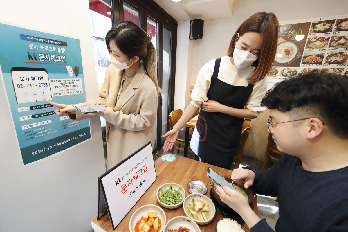▲KT 관계자가 한 식당에서 문자체크인을 홍보하고 있다. (사진제공=KT)