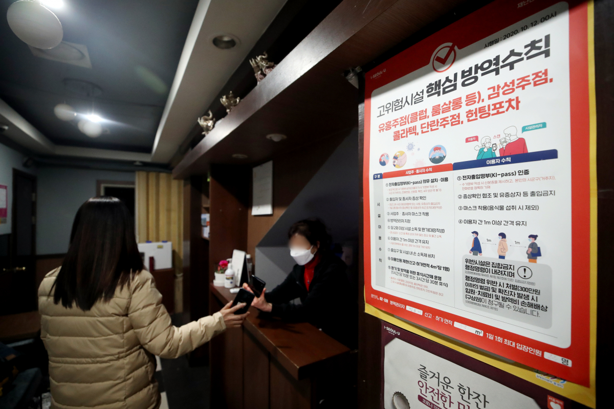 ▲유흥시설(유흥주점·단란주점·감성주점·헌팅포차)에서 QR코드 전자출입명부 작성이 의무화된 29일 오후 서울 시내 한 노래주점에서 업주가 코로나19 방역 QR체크인을 받고 있다. (뉴시스)