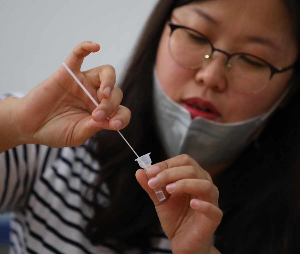 ▲서울시가 콜센터와 물류센터를 대상으로 코로나19 자가검사키트 시범사업을 시작한 17일 자가검사키트 생산업체 직원이 서울 성동구의 한 콜센터 직원을 대상으로 검사 키트 사용 시연을 하고 있다. 빨간색 한 줄이 표시된 자가진단키트는 비감염을 의미한다. (연합뉴스)