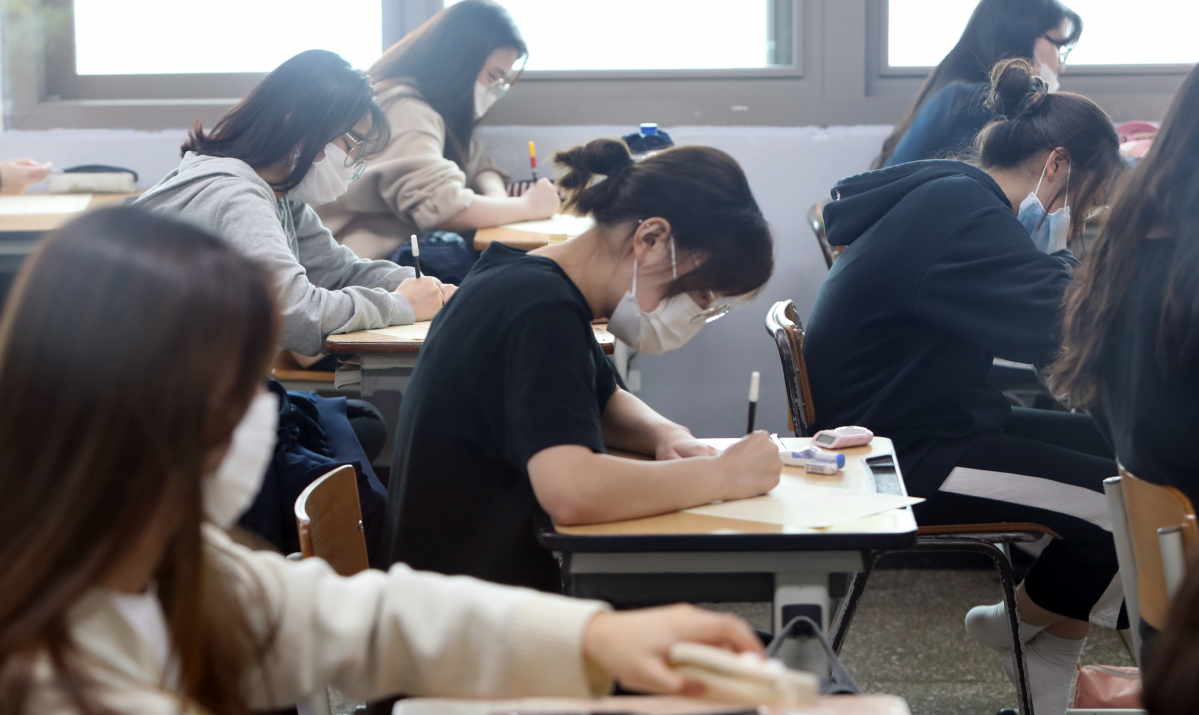▲지난해 9월 2021학년도 대학수학능력시험을 앞두고 수험생들이 9월 모의평가 문제지를 받고 있다. (뉴시스)