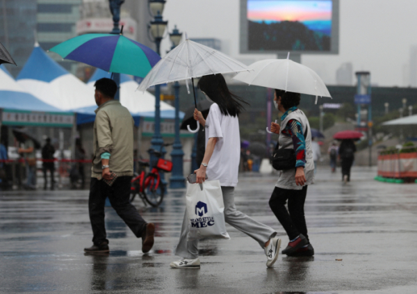 ▲서울역 앞 도로에서 시민들이 우산을 쓰고 발걸음을 옮기고 있다.  (사진출처=뉴시스)
