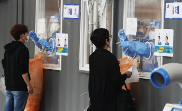 ▲0시 기준 국내 코로나19 신규확진자가 587명 발생한 28일 서울역 코로나19 임시선별검사소에서 시민들이 검사를 받고 있다. (뉴시스)
