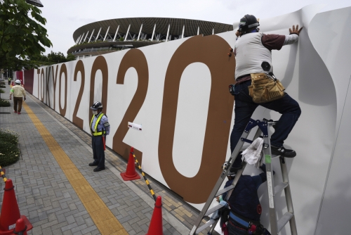 ▲도쿄올림픽 개막식이 치러질 경기장 앞에서 2일 사람들이 공사를 진행하고 있다. 도쿄/AP연합뉴스
