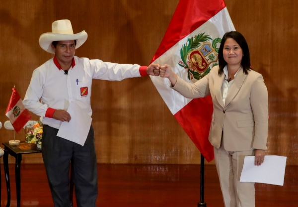 ▲ 페루 대통령 선거 결선투표에 진출한 자유페루당 페드로 카스티요(왼쪽) 후보와 민중권력당 게이코 후지모리(오른쪽) 후보가 지난달 17일 수도 리마에서 ‘민주주의 선서’에 서명한 후 주먹인사를 하고 있다. 리마/로이터연합뉴스
