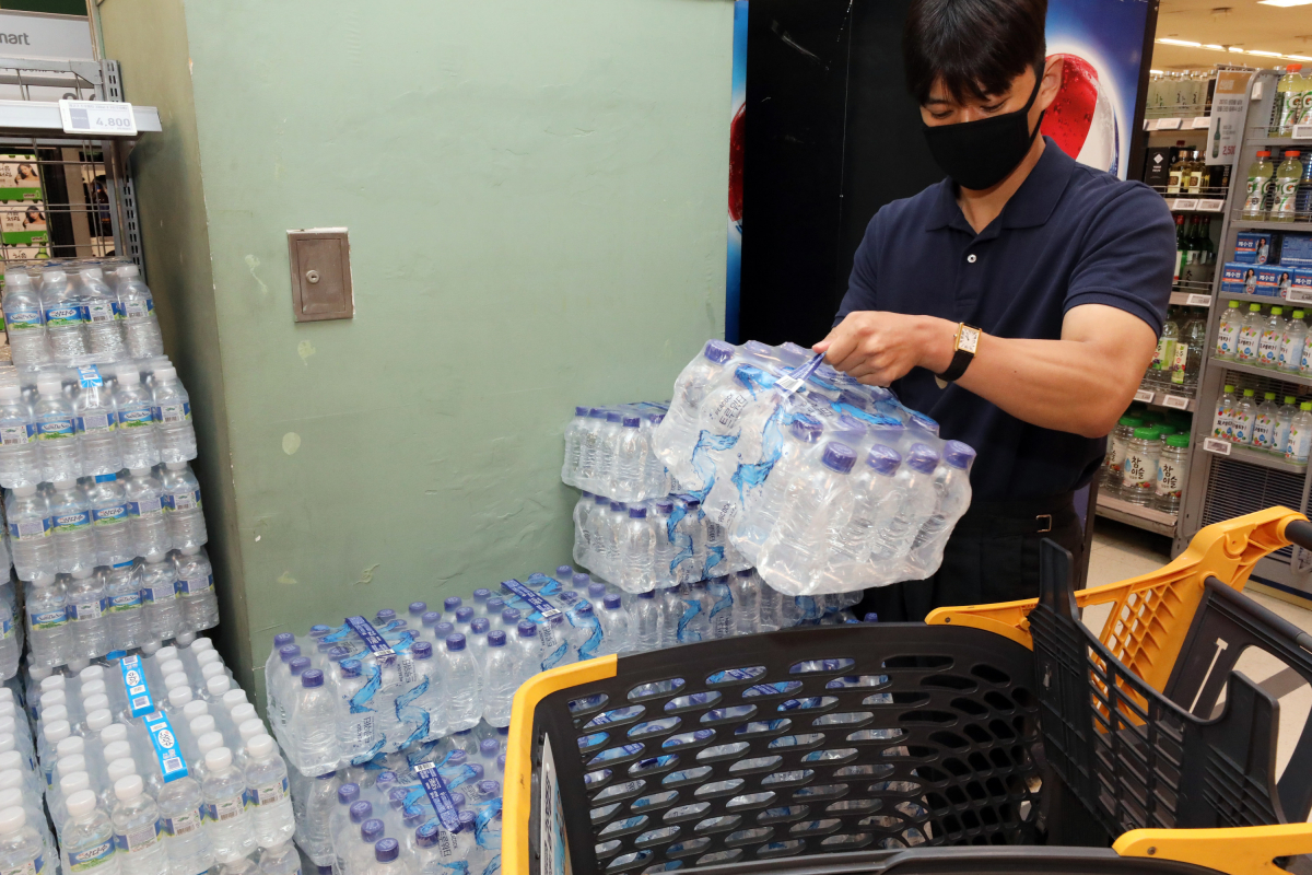 ▲이마트 성수점에서 한 고객이 '피코크' 무라벨 생수를 구매하고 있다. (사진제공=이마트)