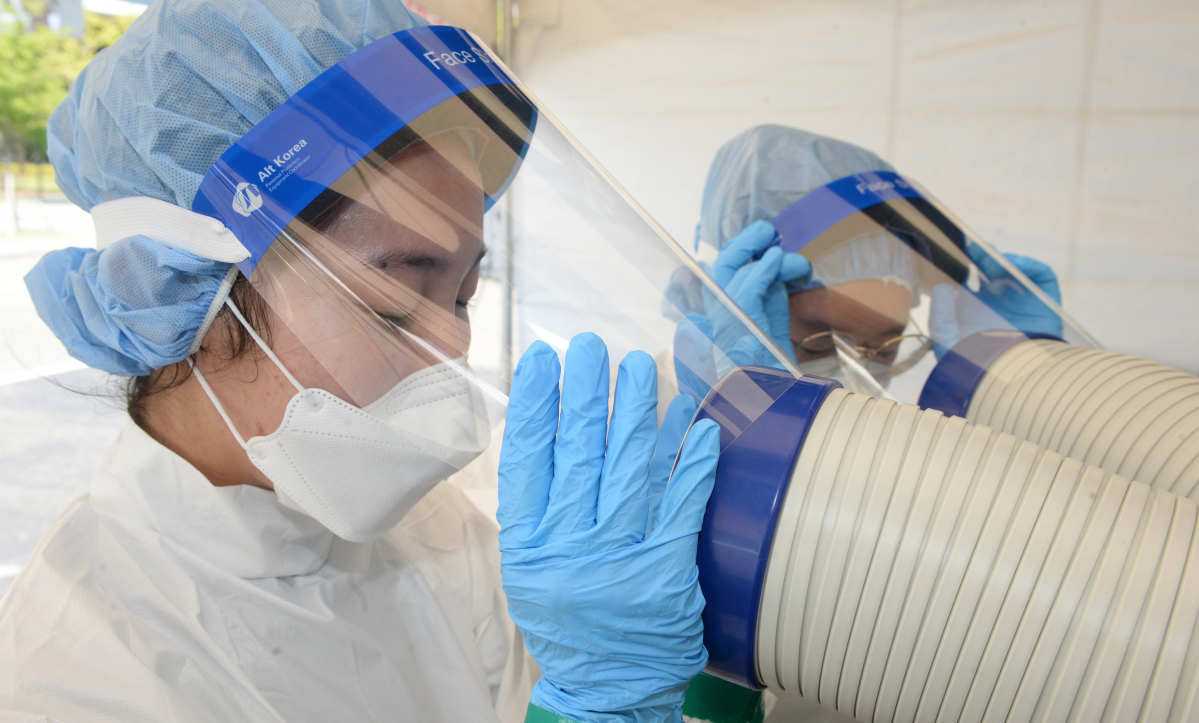 ▲울산 전역에 폭염주의보가 내려진 30일 오후 울산 남구 문수축구장 코로나19 임시 선별진료소에서 의료진들이 냉풍기 바람으로 더위를 식히고 있다.  (뉴시스)