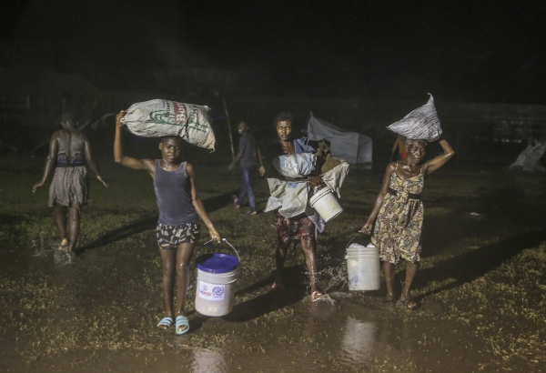 ▲16일(현지시간) 아이티 레카이의 한 난민캠프에서 지진 피해 이재민들이 열대성 저기압 ‘그레이스’로 인한 비를 맞으며 걷고 있다. 레카이/AP연합뉴스
