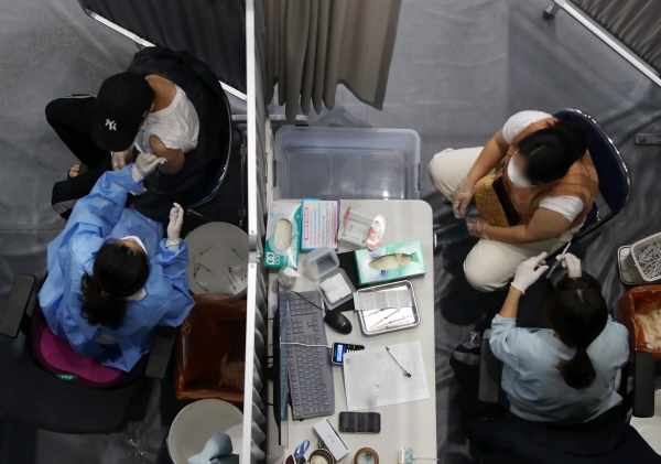 ▲6일 서울 송파구 체육문화센터에 마련된 예방접종센터에서 시민들이 접종을 하고 있다. 뉴시스
