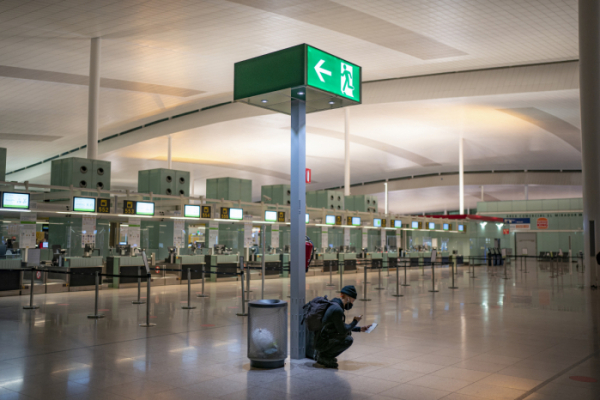 ▲스페인 바르셀로나 공항에서 한 승객이 텅빈 공항 터미널에서 여권을 사진촬영하고 있다. 바르셀로나/AP뉴시스