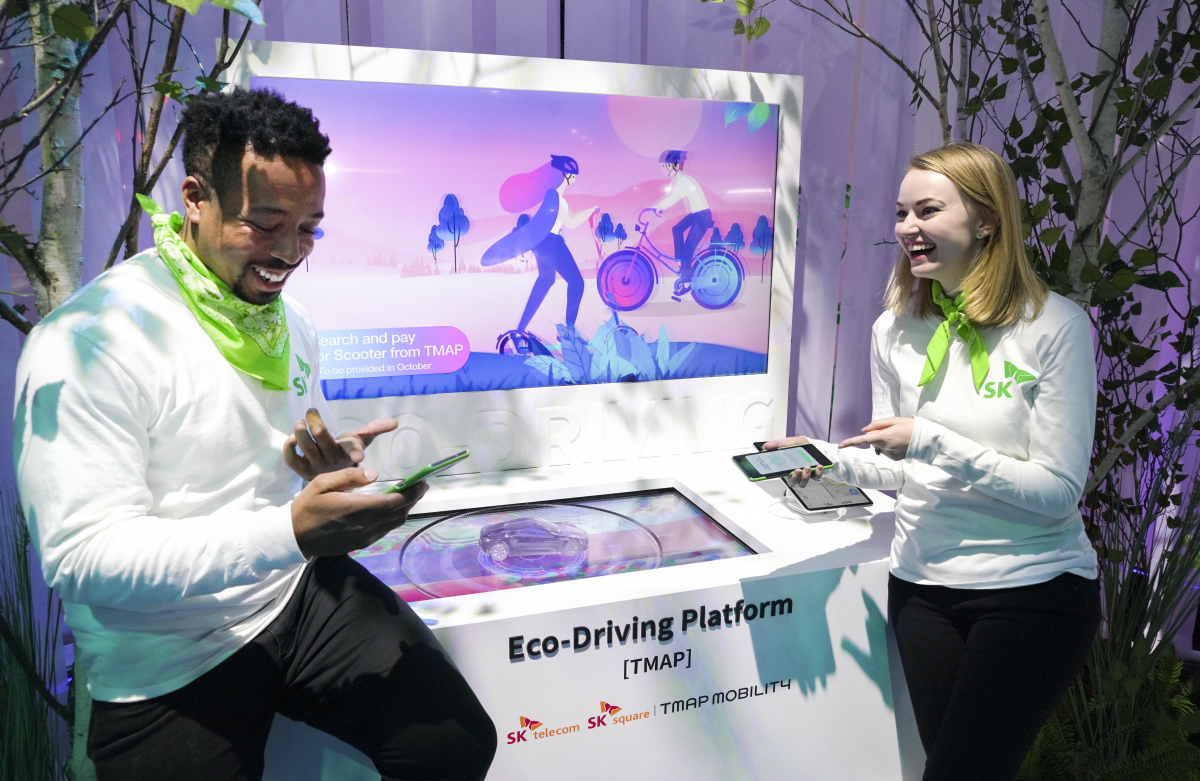 ▲SK텔레콤이 SK 관계사와 함께 마련한 공동 전시 부스에서 최적 경로 내비게이션 '티맵'을 체험하고 있다. (사진제공=SK텔레콤)