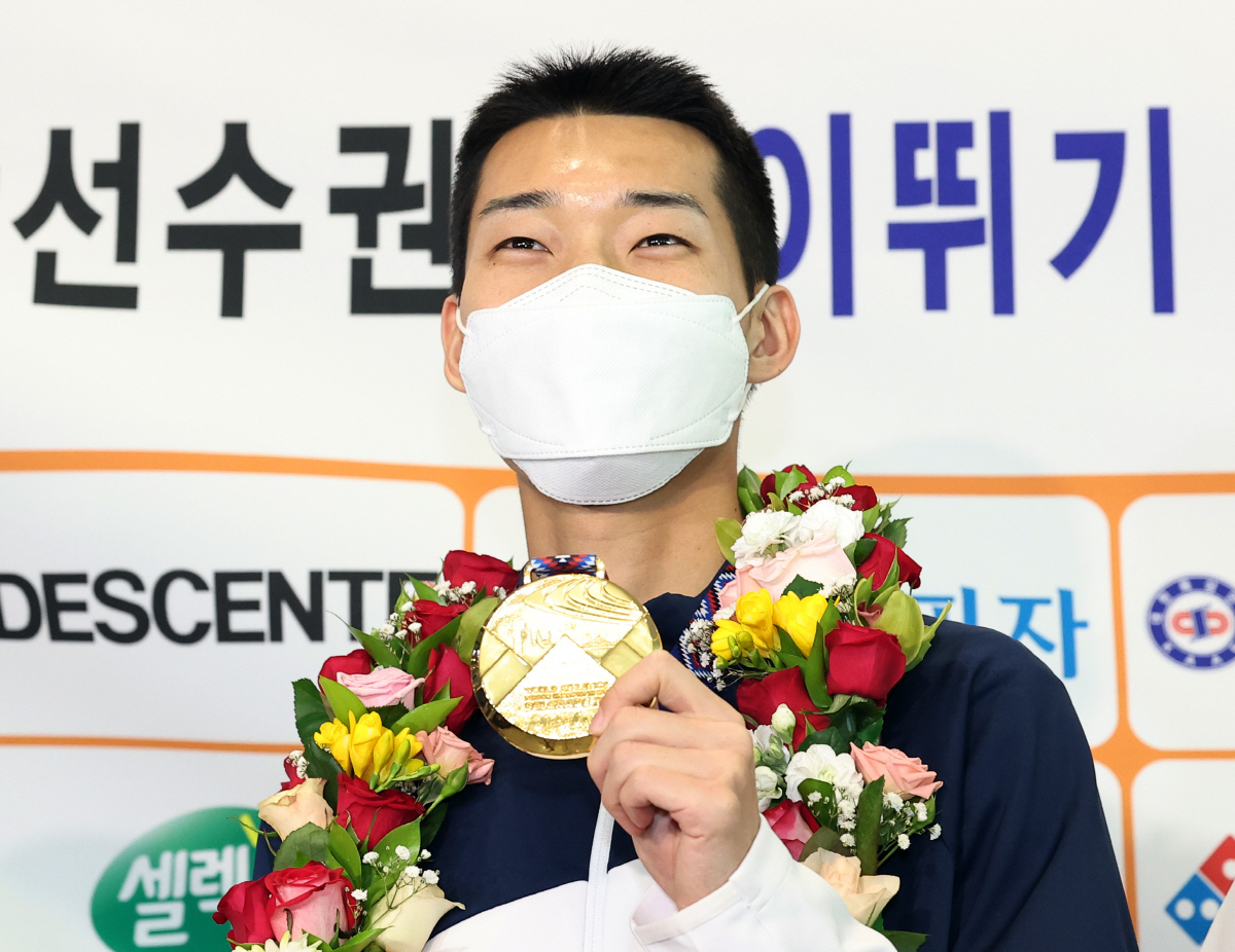 ▲세르비아 베오그라드에서 열린 2022 세계실내육상선수권대회 남자 높이뛰기 결선에서 2ｍ34를 뛰어 우승한 ‘스마일 점퍼’ 우상혁이 22일 영종도 인천국제공항 제1여객터미널을 통해 귀국한 뒤 금메달을 들고 환하게 웃고 있다. (연합뉴스)
