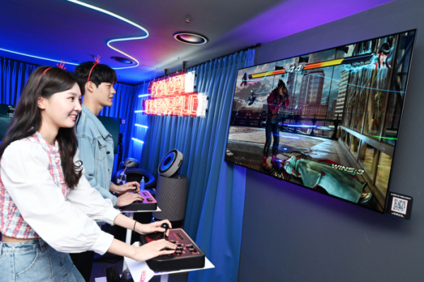▲LG전자가 최근 오픈한 부산 광안리 ‘금성오락실’에서 LG 올레드 TV를 통해 격투 게임을 즐기고 있다.  (사진제공=LG전자)