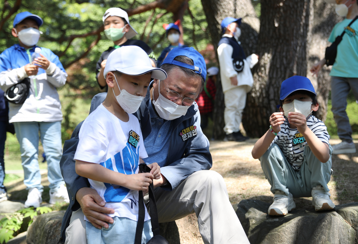 ▲문재인 대통령이 5일 청와대 녹지원에서 열린 2022년 어린이날 100주년 기념 청와대 어린이 초청행사에서 아이들과 대화하고 있다. (뉴시스)