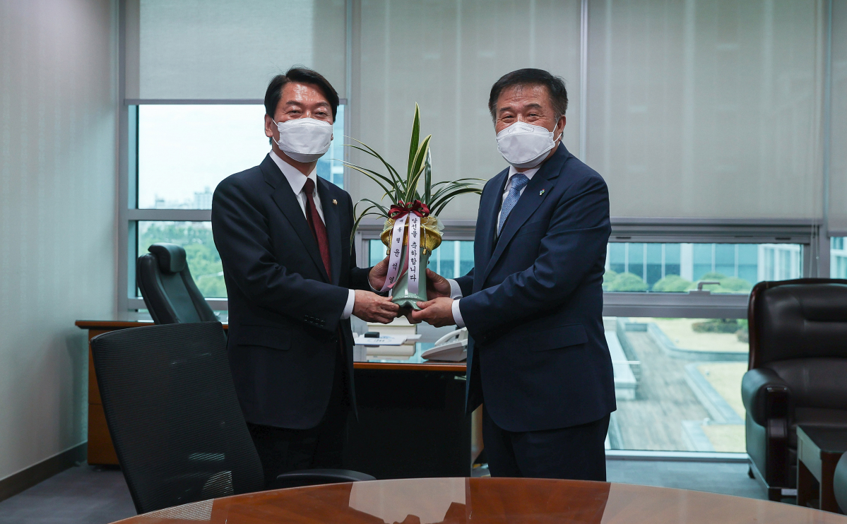 ▲[서울=뉴시스] 고범준 기자 = 안철수 국민의힘 의원이 7일 서울 여의도 국회 의원회관에서 의원실을 예방한 이진복 대통령실 정무수석에게 윤석열 대통령의 축하 난을 전달받고 있다. (공동취재사진) 2022.06.07. photo@newsis.com