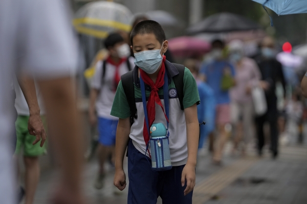 ▲중국 베이징에서 27일 마스크를 쓴 어린이가 축 늘어진 채 걷고 있다. 베이징/AP뉴시스

