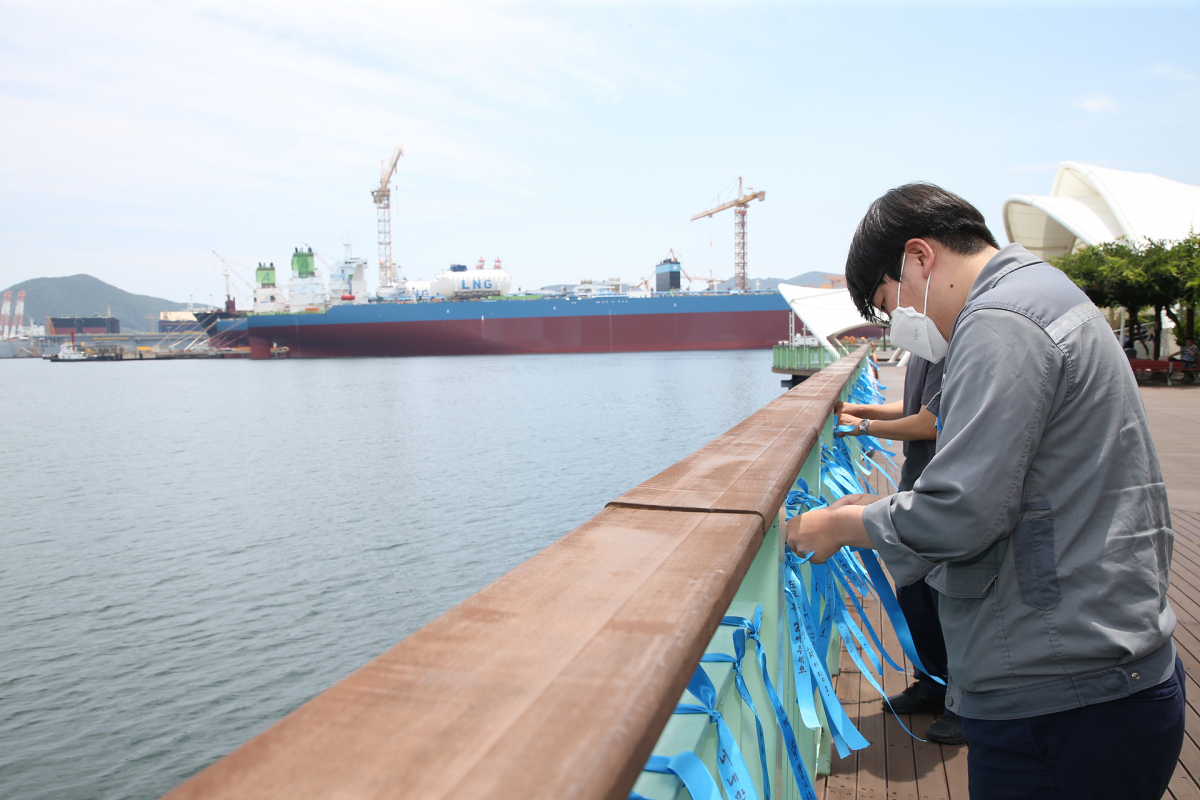 ▲대우조선해양 직원들이 1도크 정상화를 기원하는 메시지가 적힌 리본을 달고 있다. (사진제공=대우조선해양)