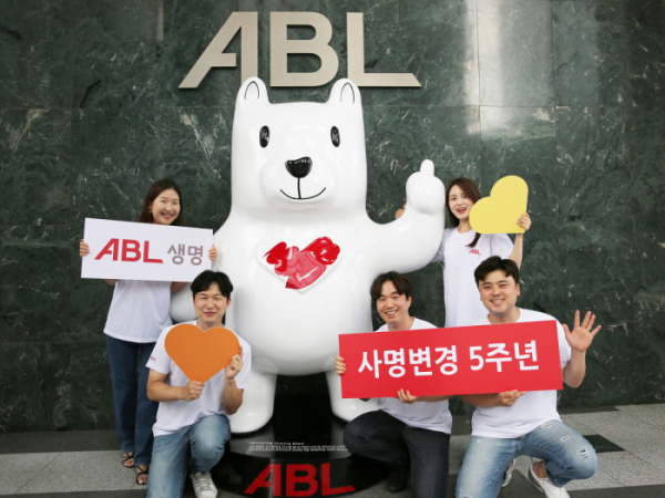 ▲ABL생명 영보드(Young Board) 직원 5명이 회사 5대 핵심가치 중 하나인 ‘배려’의 의미를 형상화한 ‘배려하자곰’ 조형물 앞에서 사명 변경 5주년 기념사진을 촬영하고 있다.
